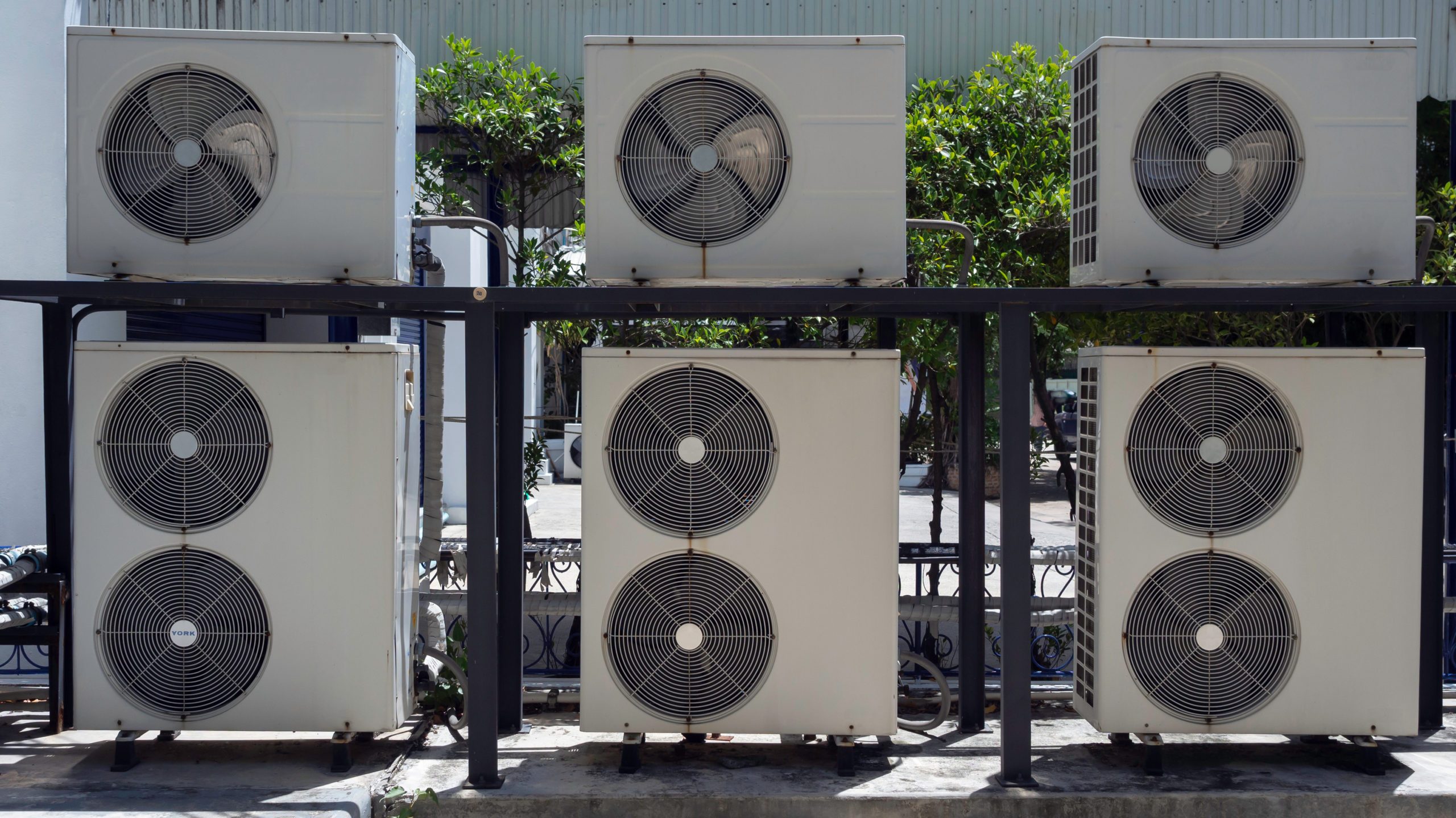 Group of air conditioning compressor unit. Group of air conditioning compressor unit installed outside the building. Outdoor air condensers installed stacking.